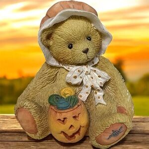 Vintage Cherished Teddies figurine named Connie, holding a jack-o'-lantern.